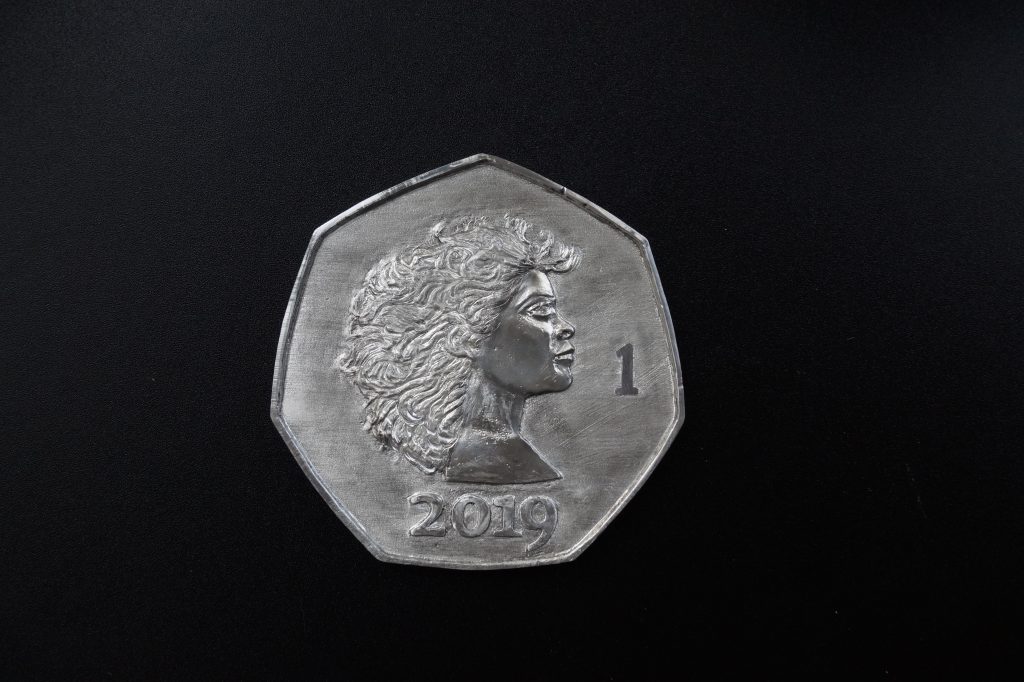 Pewter coin by Lee Devonish. Artist's Proof obverse