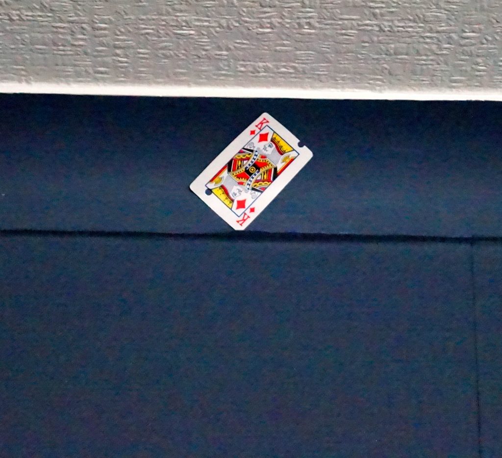 A playing card wedged in ceiling coving 11/01/19