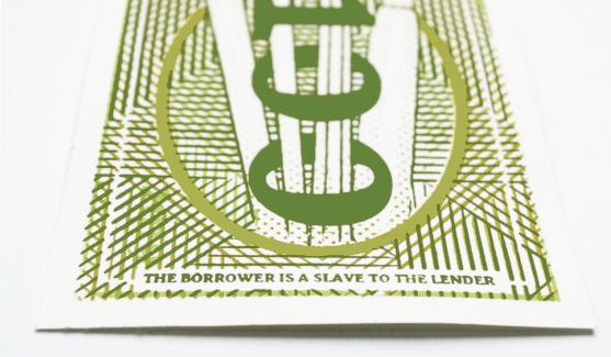 Bottom of rear side of banknote saying: "the borrower is a slave to the lender".