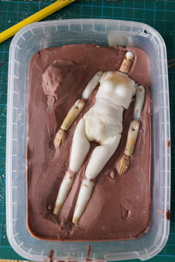 3D printed figure in clay bed for casting